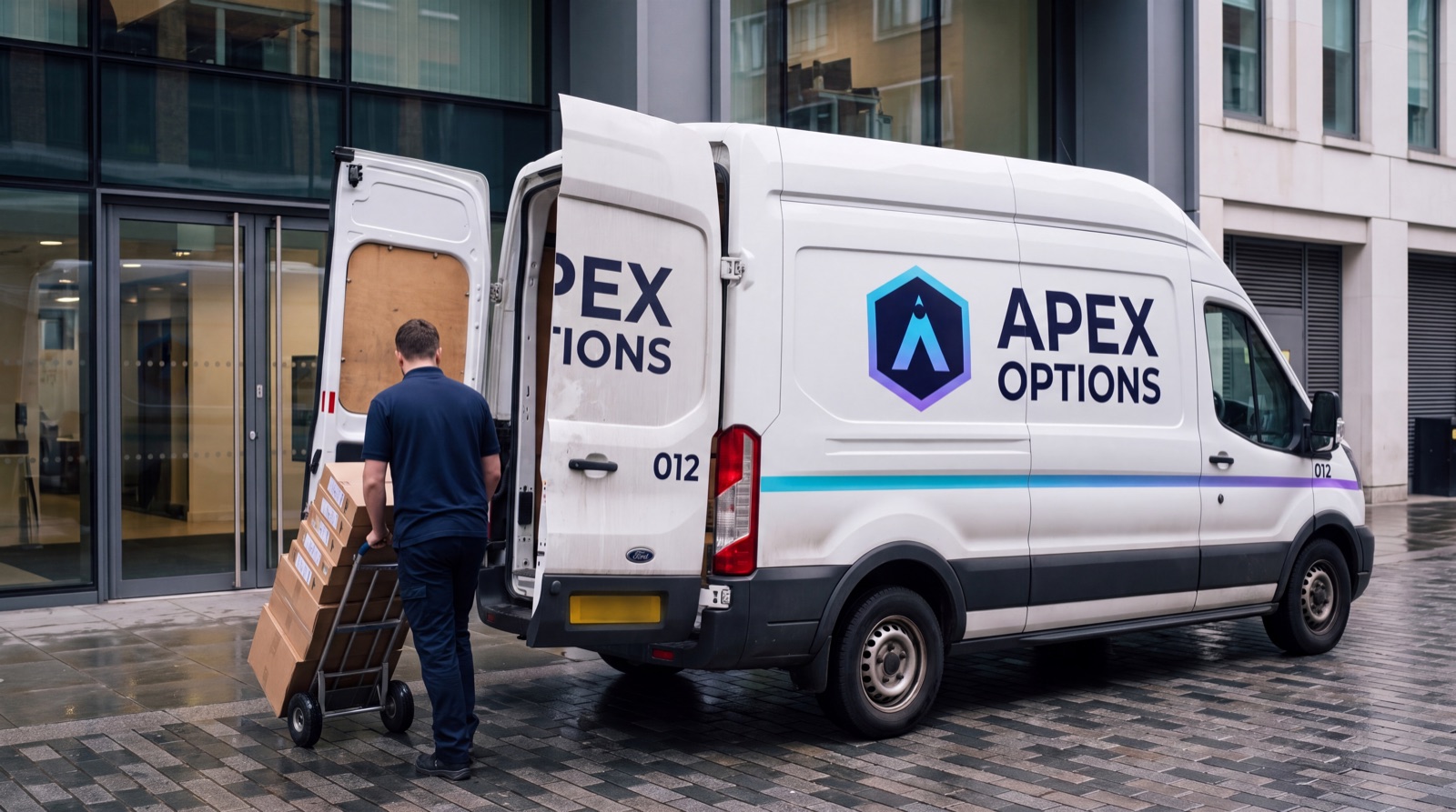 Technician wheeling boxed laptops from an Apex Options van into an office